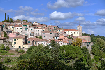 stone houses and medieval church tower in Scansano village in Tuscany