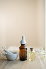 natural skincare with aromatherapy oil and flower. clean beauty cosmetic and product for skin. copy space . vertical
