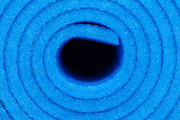 Naklejka premium Rolled-up lightweight foam yoga mat