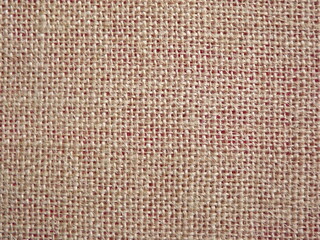 Jute fabric with pink undertone close-up as background. High quality photo