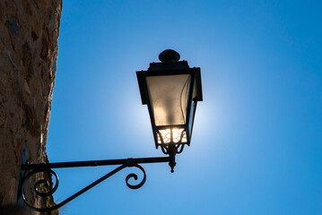 Fototapeta na wymiar A close-up of an old street lamp on blue sky background