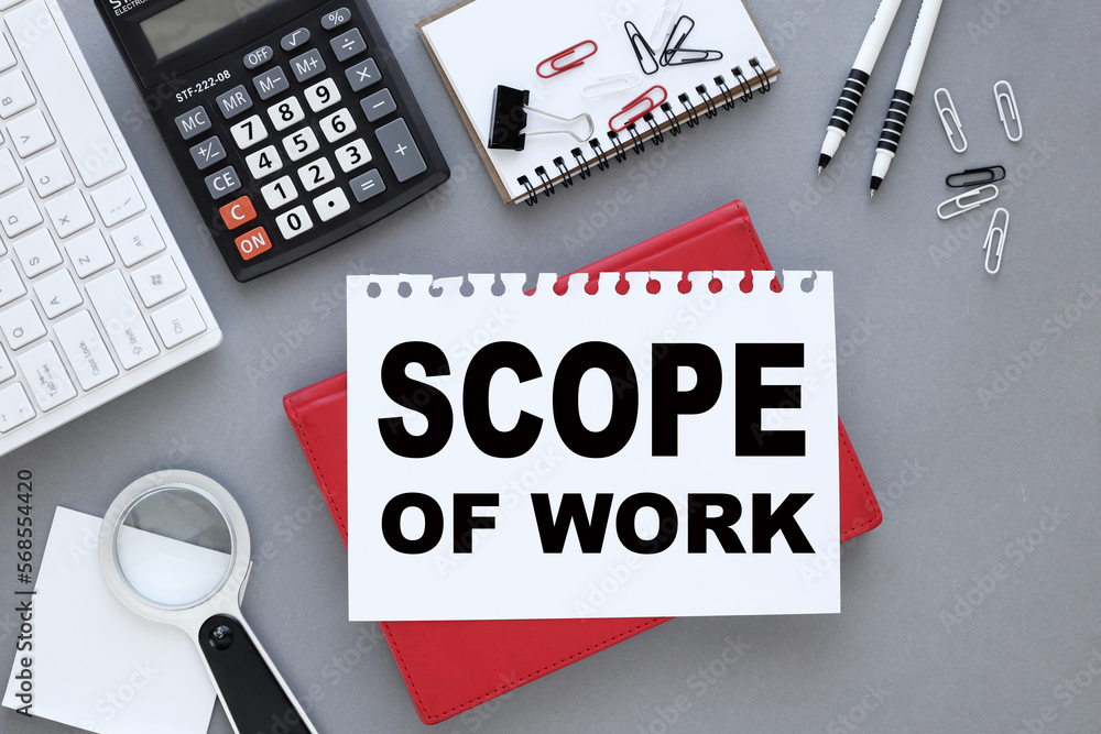 Aufkleber scope of work. gray background with white keyboard and text on paper