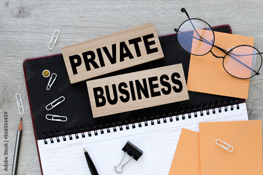 Poster private business . text on wooden blocks on a notepad.work table