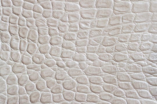 Texture of genuine leather close-up, embossed under light color print