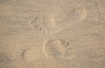 a top view with two footprints on the sand