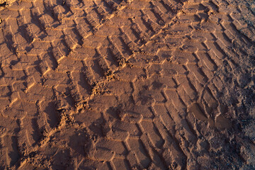 Tire tracks from wheel loader in the sand