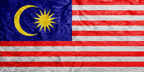 Malaysian flag on a textured background. Concept collage.