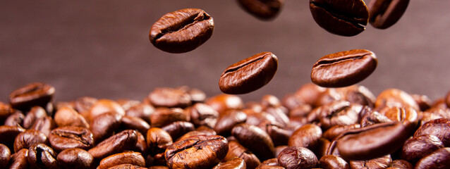 Coffee break background. Hot coffee in cup and roasted coffee beans on a wooden table. Copy space