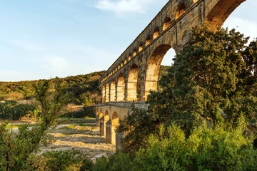 Peel and stick wall murals Pont du Gard Three tiers of ancient Roman  Pont Du Gard aqueduct reflecting in Gardon river in Southern France