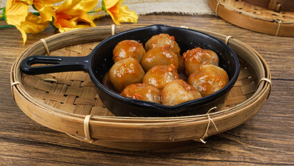 Cilok (Aci Dicolok) is a Sundanese snack originated from Indonesia. served in wok pan with peanut sauce