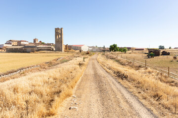 dirt road on a summer landscape entering Tamariz de Campos, province of Valladolid, Castile and...