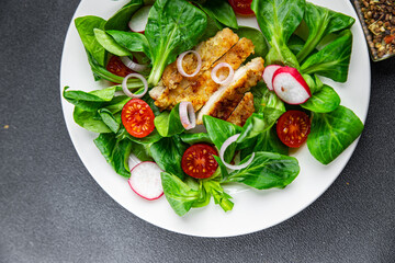 healthy salad chicken meat, vegetables, tomato, radish, green leaves mix lettuce healthy meal food snack on the table copy space food background rustic top view keto or paleo diet