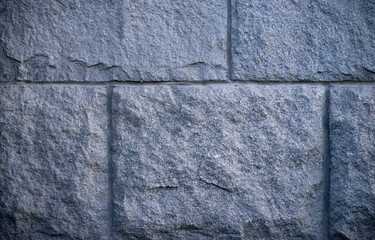 Photo of the texture of the granite foundation. Vintage foundation at the house.Square stone blocks.A stone wall.