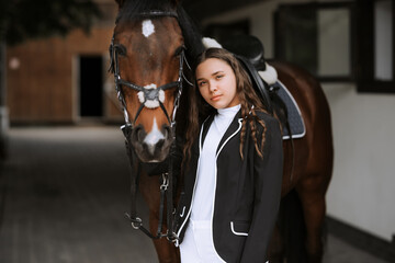 Rider and horse go to the country after the race. Outdoor shot, sport and fashion concept.