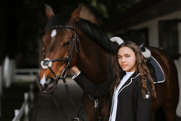 Fototapeta premium Rider and horse go to the country after the race. Outdoor shot, sport and fashion concept.