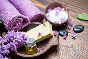 Lilac spa setting with natural soap and pure essential oil - 568562885