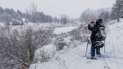 While snowshoeing, a winter storm passes through Brampton on a snowy day at Claireville Convservation Area in Ontario, Canada