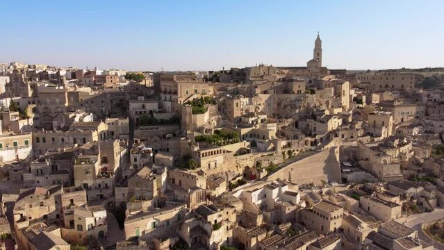 Aerial footage Sassi di Matera Basilicata, South Italy.Drone view of Sasso Caveoso and Civita districts, old city houses carved in rock caves, stairs, Cathedral bell tower, Unesco heritage from above