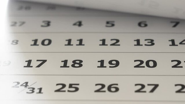 flipping through the pages of the flip calendar. 