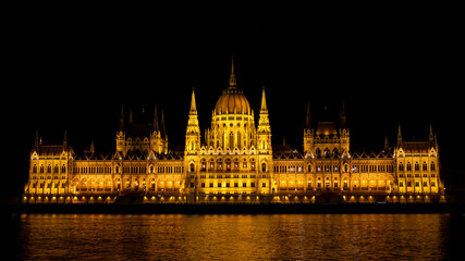 Fototapeta na wymiar Budapest Parliament Building at night from across the Danube River in Hungary
