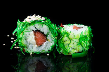 Sushi rolls with tuna, cream cheese in marinated chuka seaweed.