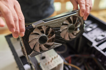 Installing a video card on the motherboard. Installing computer components in a open PC case. DIY...