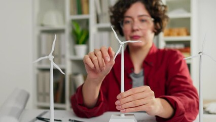Energy of the future, Energy business owner Slowly Brainstorming with colleagues Wind turbine 3d model mini mockup In slow motion Professional worker is at the construction site, wind farm
