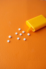 artificial sweetener container on orange background 