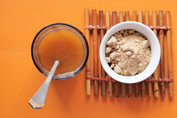 mixing brewers yeast flakes in a glass of water 