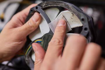 Internal parts of an old personal computer. Dusty motherboard, video card and fan. The master...