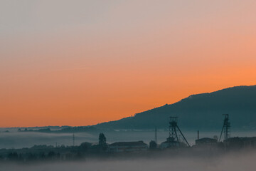 Fototapeta na wymiar Precious metals and rare earths mine in the middle of the fog at sunset on golden hour