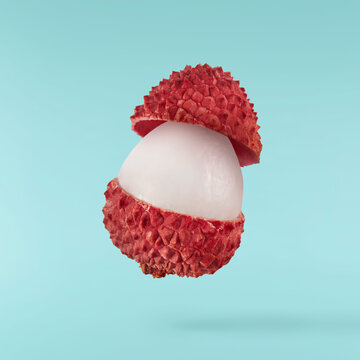 Fresh ripe red lychee falling in the air isolated