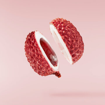 Fresh ripe red lychee falling in the air isolated