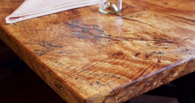 Close up of a high end wooden table. Beautiful detailed custom wooden restaurant table.