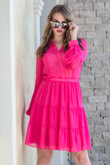 Girl in a pink dress with glasses