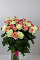 Bouquet of pink, yellow roses. Composition of multi-colored roses. Background for a postcard.