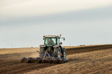 Farming's gentle touch, tractor cultivating the land with care