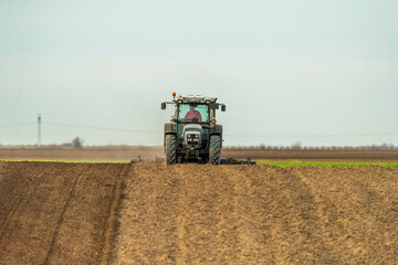 Obraz premium The heartbeat of the farm, tractor preparing the fields for a new cycle of life