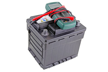 Isolated twelve volt battery with multimeter resting on top.