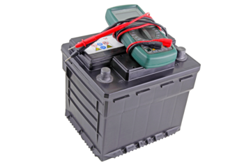 Isolated twelve volt battery with multimeter resting on top.