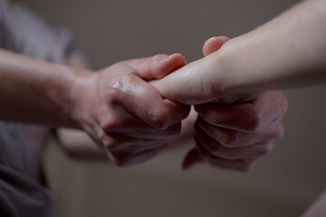 Close-up of a hand massage given by a professional masseuse to her client