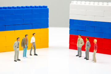 Miniature people. National Ukrainian and Russian flag from colored blocks constructor. The problem...
