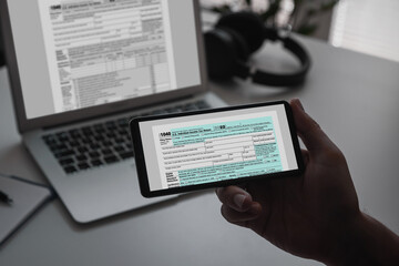 US tax form on smartphone, tax income concept