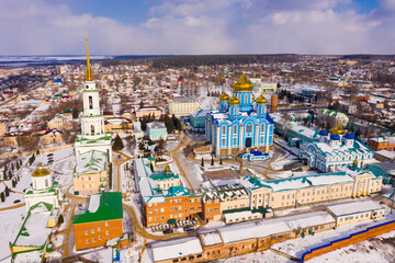 Fototapeta na wymiar Aerial panoramic view of architectural complex of Nativity of Mother of God Monastery in small Russian town of Zadonsk on winter day..