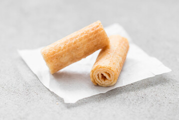 Two sweet waffle rolls. On paper Light grey background