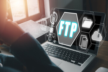 FTP, File transfer protocol, Person using laptop computer on desk with File transfer protocol icon...