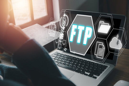 FTP, File transfer protocol, Person using laptop computer on desk with File transfer protocol icon on virtual screen, Internet and communication technology concept.