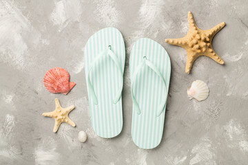 Striped flip flops on concrete background, top view