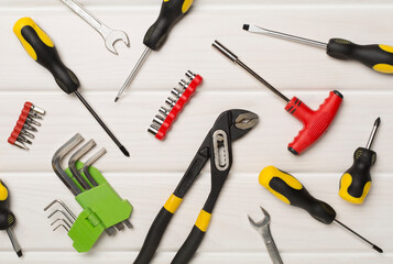 Set of tools on wooden background, top view