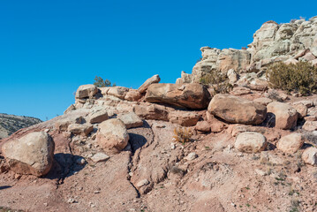 A desert hill with boulders, copy space in the blue sky on the left